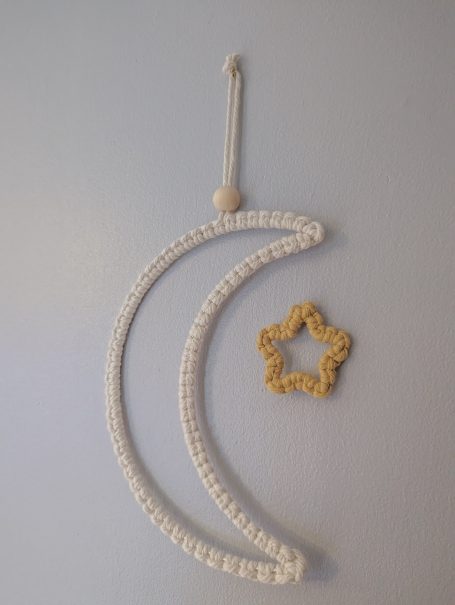 White crescent moon and yellow star wall décor.