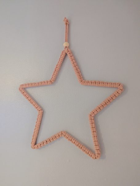 Blush pink-coloured star-shaped decoration wall hanging.